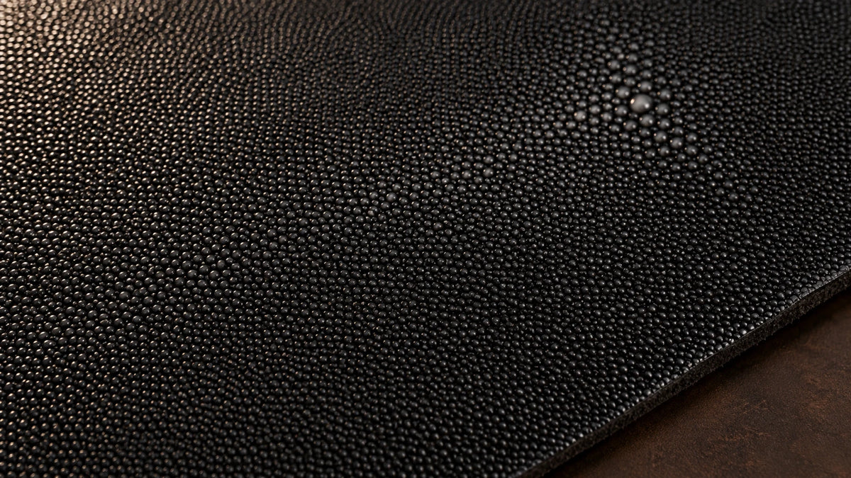 Black stingray leather with a beaded surface and a light central marking
