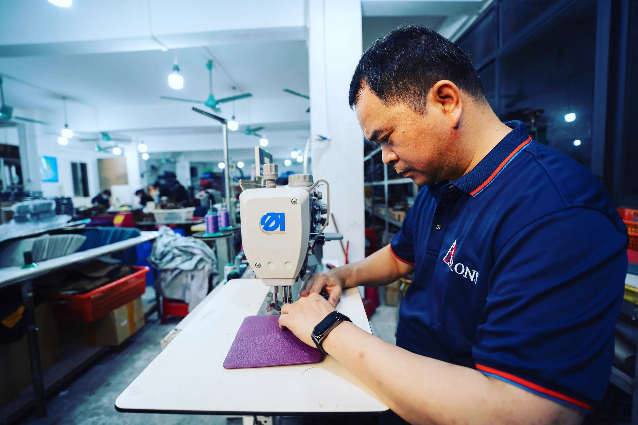 Aarons Leather craftsman sewing a leather product