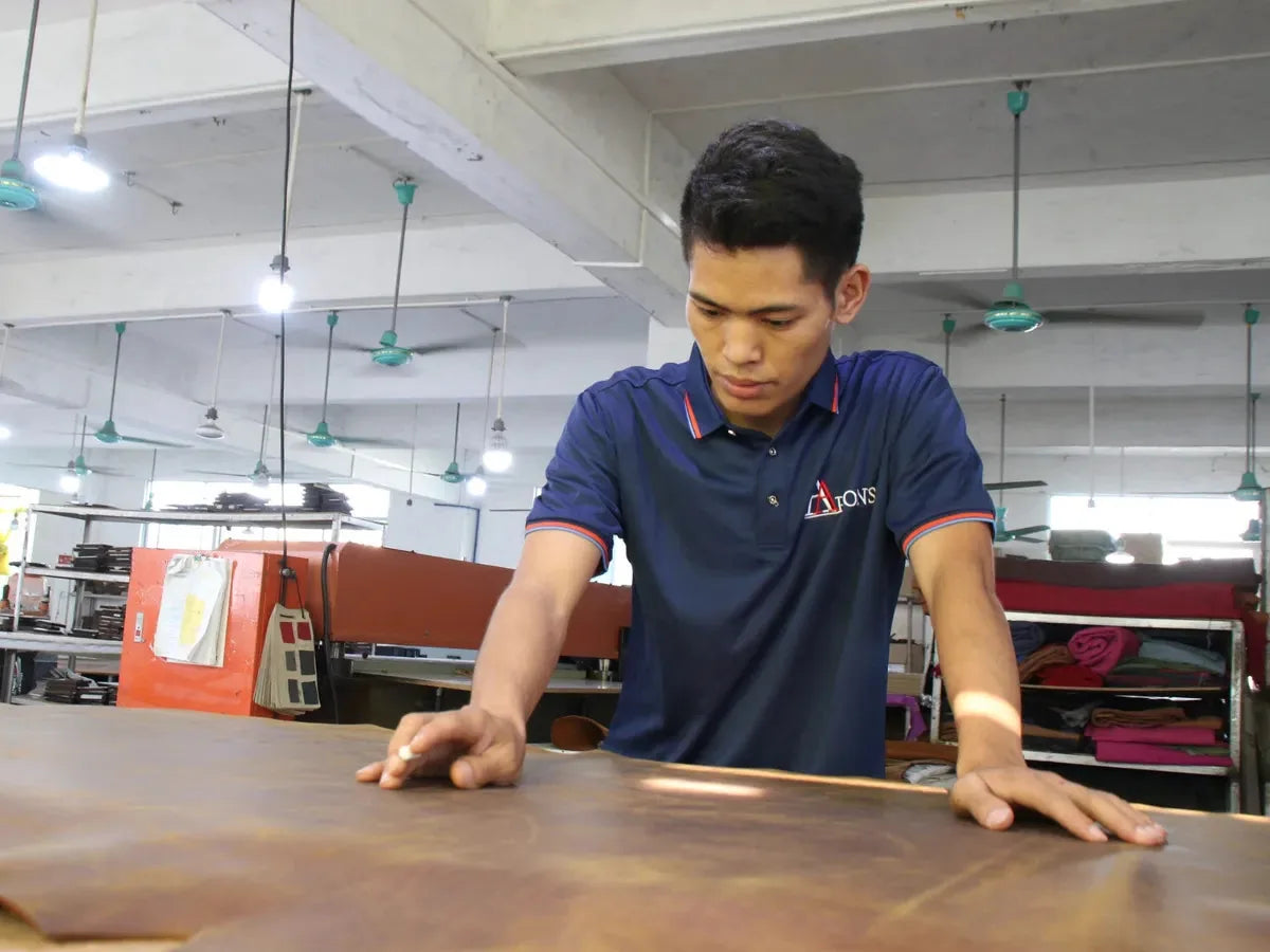 Aarons Leather workshop worker inspecting a leather hide