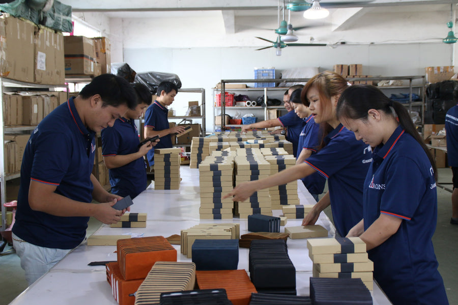 Aarons Leather team checking a large batch of finished leather goods before packing