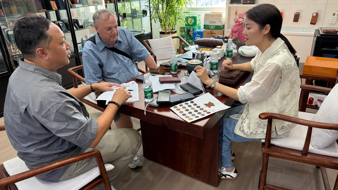 Customer from New Zealand discussing leather phone-case samples with the Aarons Leather team