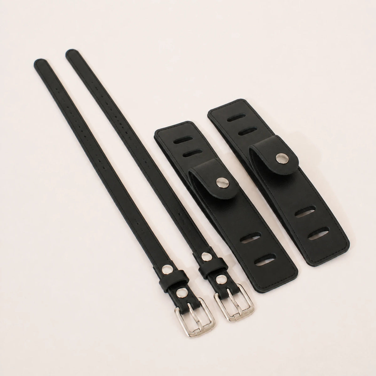 Black full-grain leather equestrian accessory set from a 45 degree angle