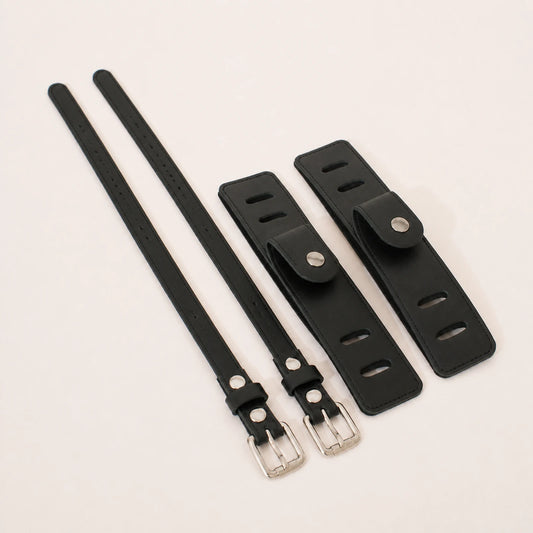 Black full-grain leather equestrian accessory set from a 45 degree angle