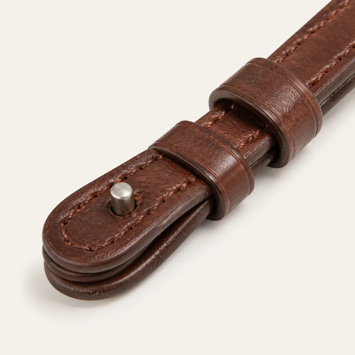 Close-up of leather rein stitching keeper and hook-stud end