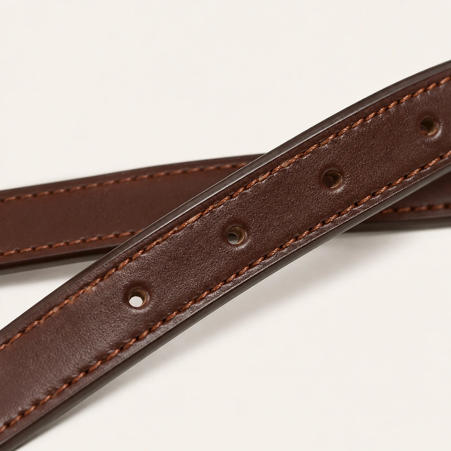 Close-up of stirrup leather grain stitching and adjustment holes