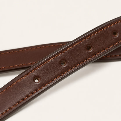 Close-up of stirrup leather grain stitching and adjustment holes