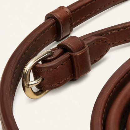 Close-up of leather horse rein buckle and keeper construction