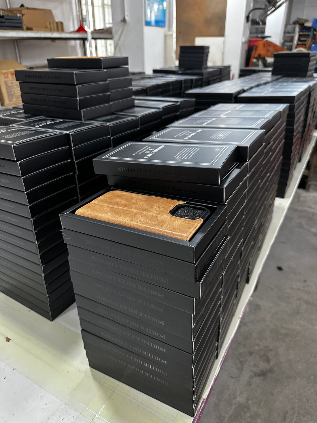 Finished leather phone cases placed into branded packaging