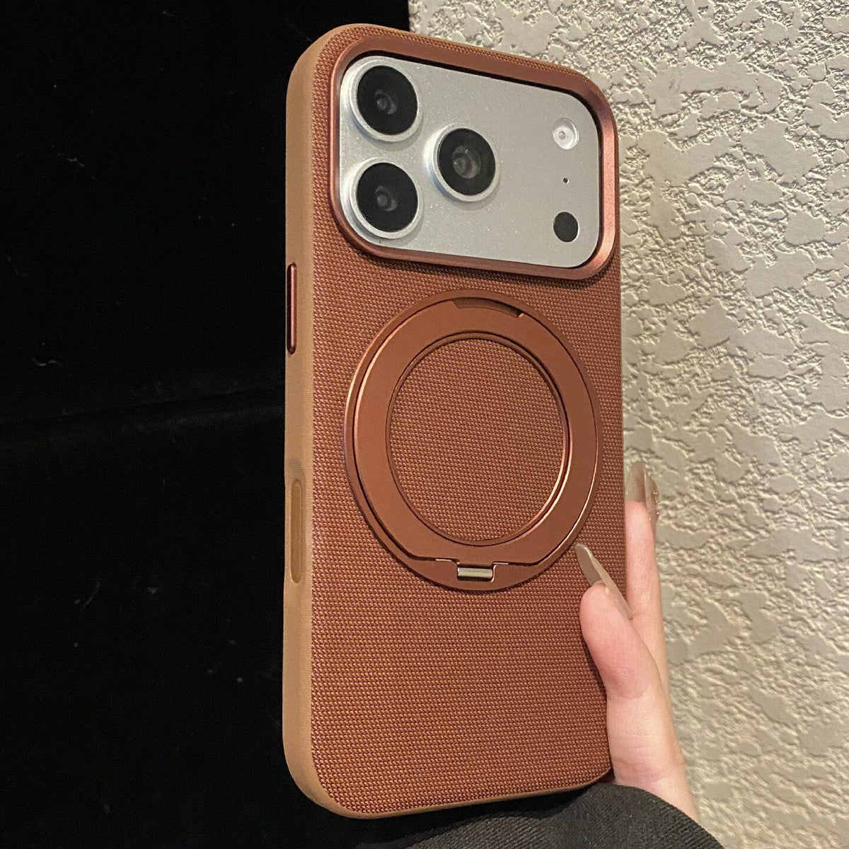 Russet-brown textile-finish phone case with the rear ring stand closed.