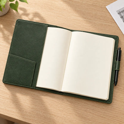 Forest green A5 leather notebook cover with blank refill on a desk