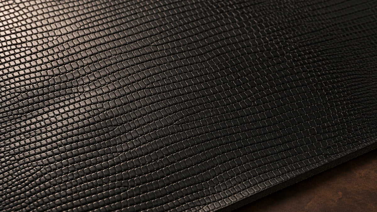 Black lizard leather surface with a closely spaced scale pattern