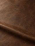 Matte brown surface with fine creases, uneven shading and a broad fold