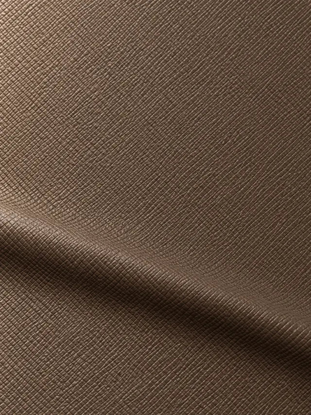 Taupe surface covered in a fine regular diagonal crosshatch pattern