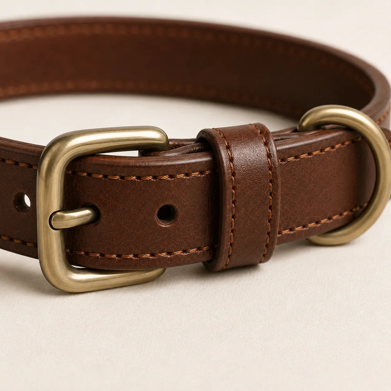 Close-up of brown leather dog collar buckle D-ring and keeper loop