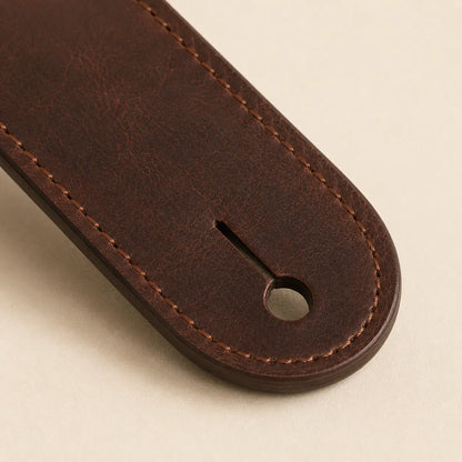 Close-up of guitar strap end slot and full-grain leather edge finishing