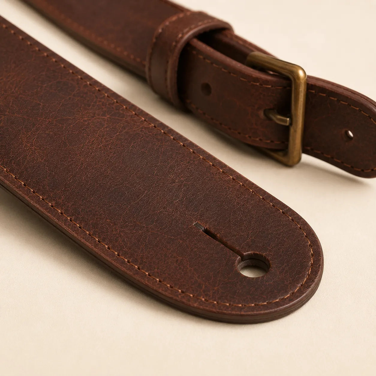 Leather texture stitching and strap thickness detail on guitar strap