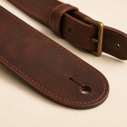 Leather texture stitching and strap thickness detail on guitar strap