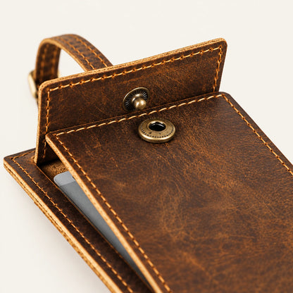 Snap fastener detail on the rectangular leather luggage tag privacy cover