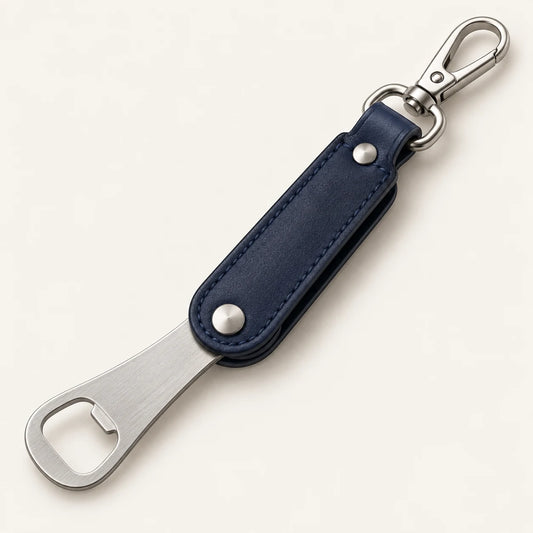 Bottle-opener plate rotated out from the lower pivot of the navy leather keyring