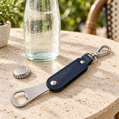 Open leather bottle opener keyring beside a plain bottle and cap; props not included