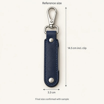 Reference keyring dimensions of 14.5 centimetres including clip by 3.3 centimetres closed width; final size confirmed with sample