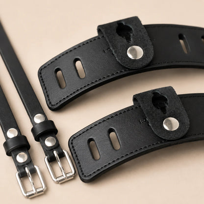 Close-up of leather spur guard slots snap tab and metal buckles