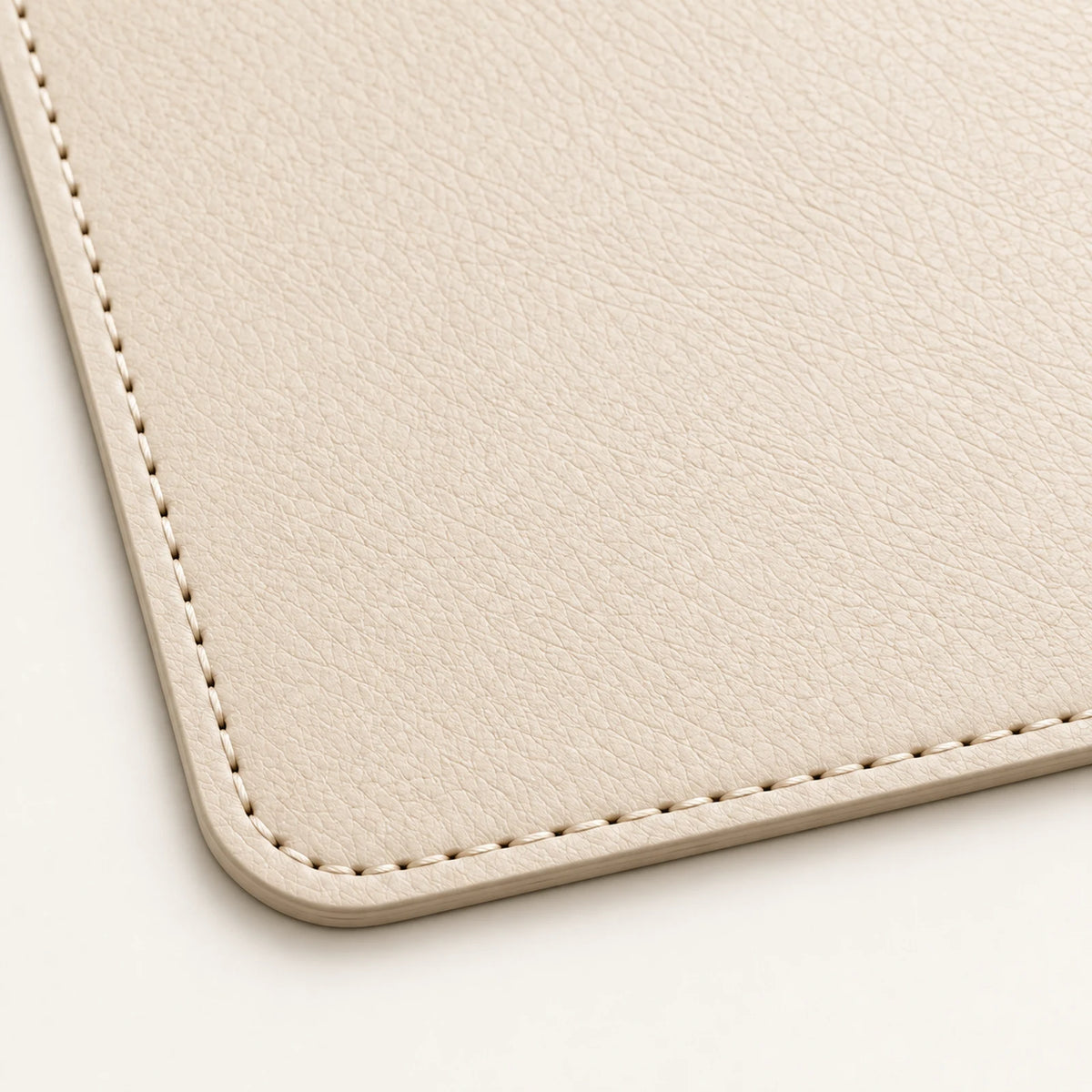 Close-up of tonal stitching and rounded edge on the genuine leather tray mat