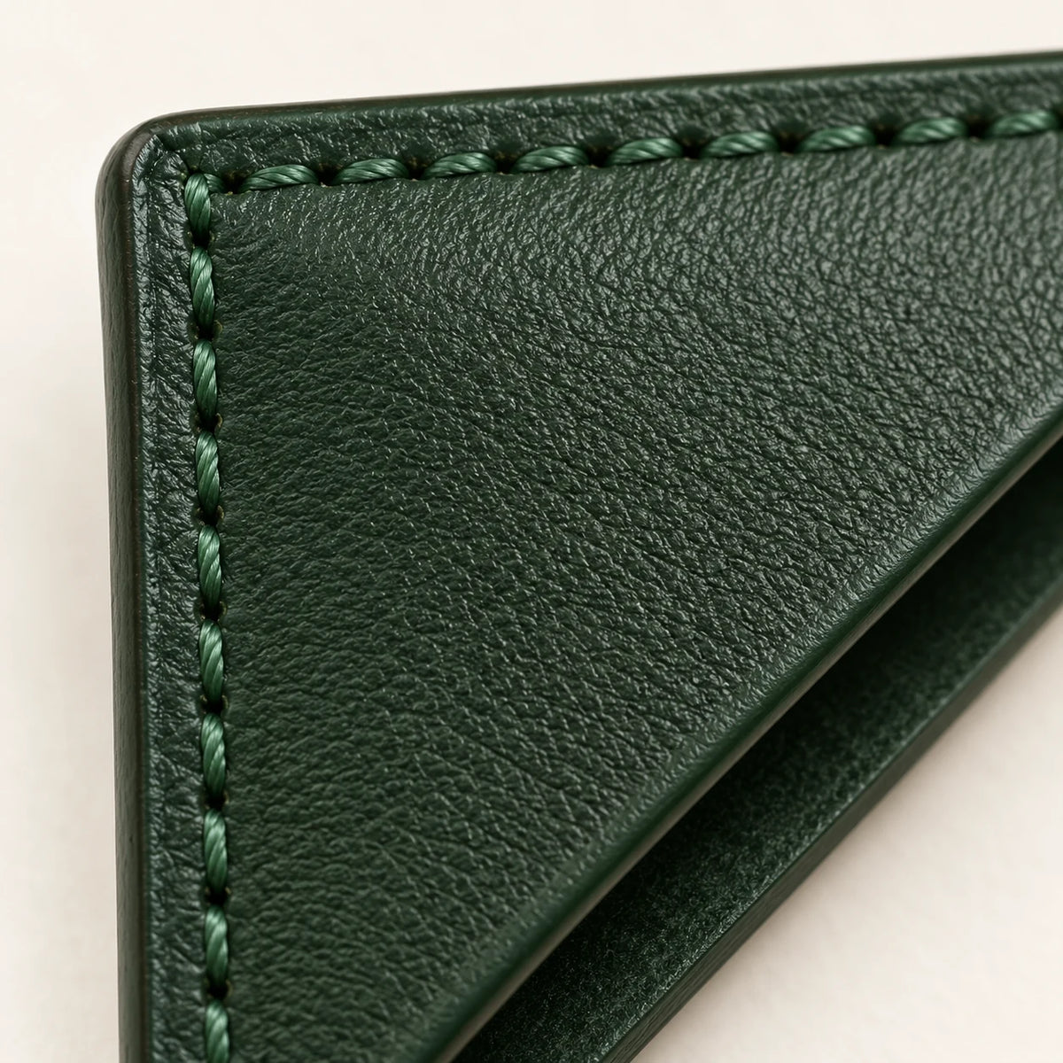 Leather grain, edge and stitching detail on the triangular bookmark