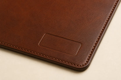 Close-up of leather grain stitching and blank logo area on custom leather desk mat