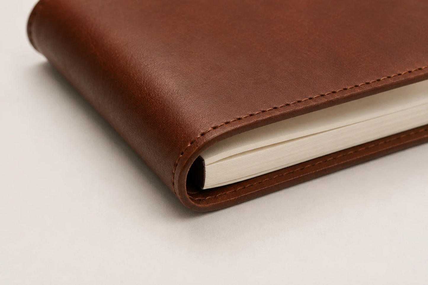 Leather journal notebook spine edge and removable paper insert detail