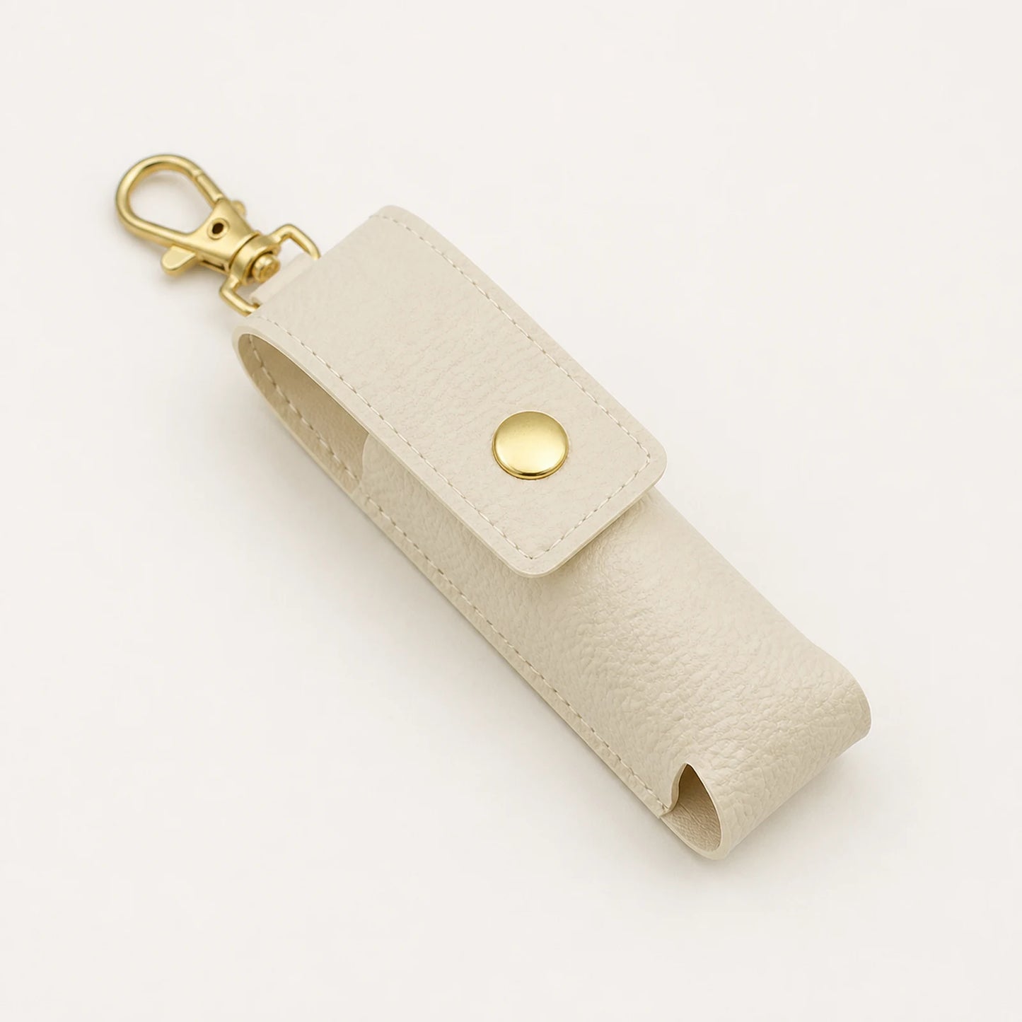 Portable lipstick holder keychain in ivory from an alternate angle