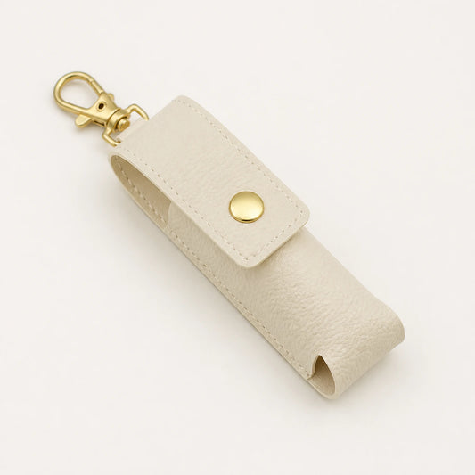 Portable lipstick holder keychain in ivory from an alternate angle