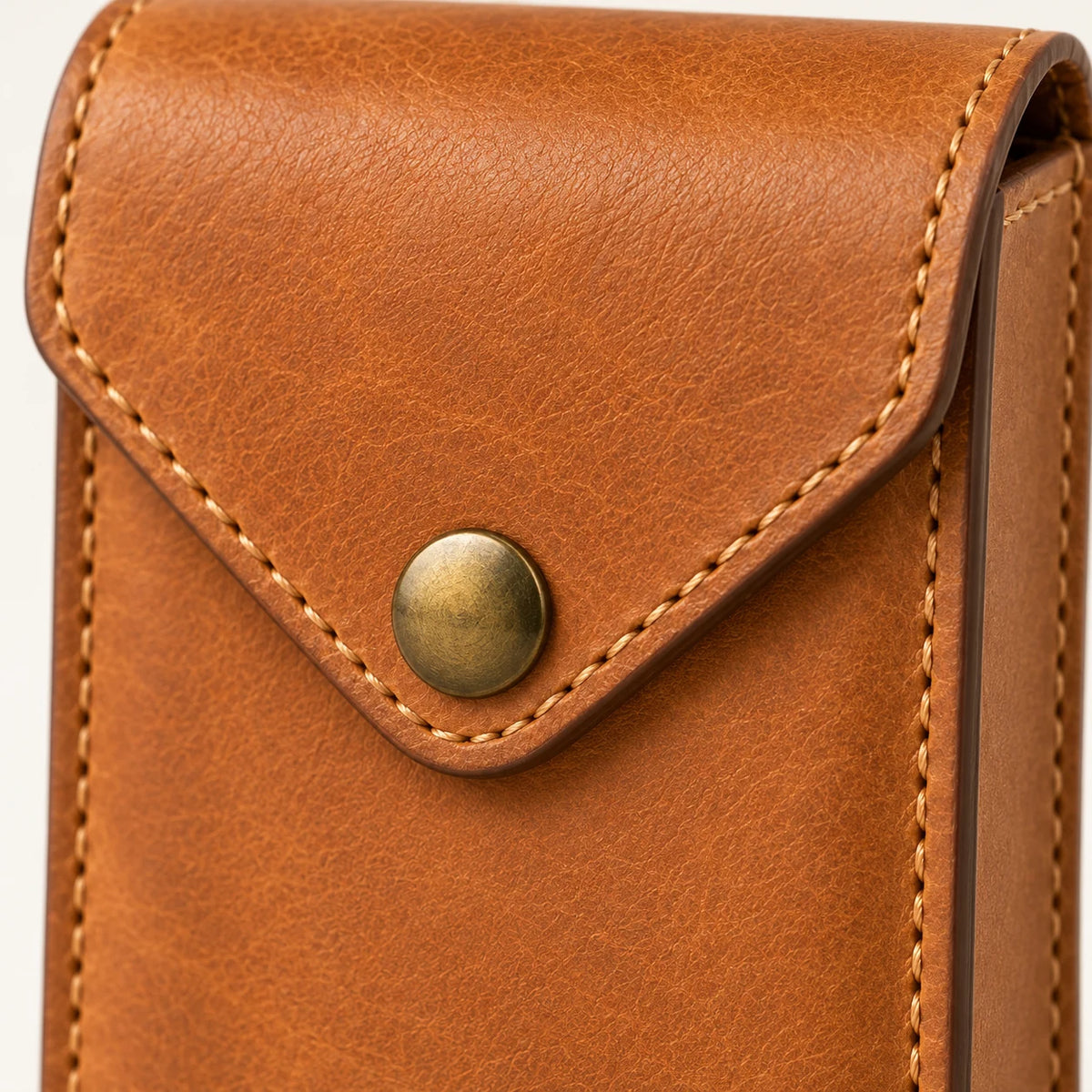 Close-up of the snap, tan stitching and finished edge on the card case