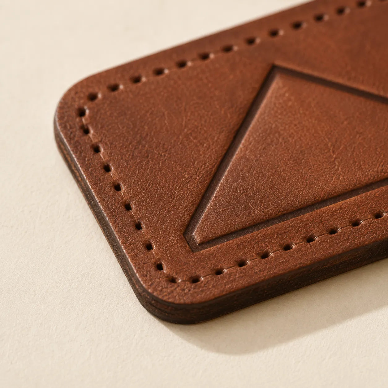 Leather hat patch edge stitching holes and full-grain texture detail