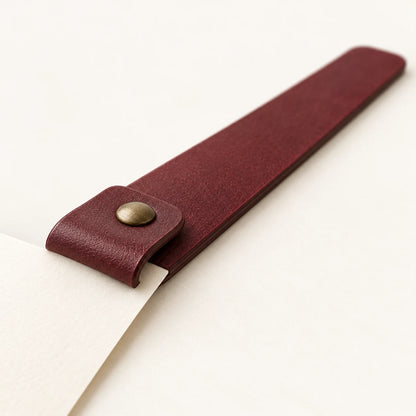 Page placement under the folded top of the custom riveted leather bookmark