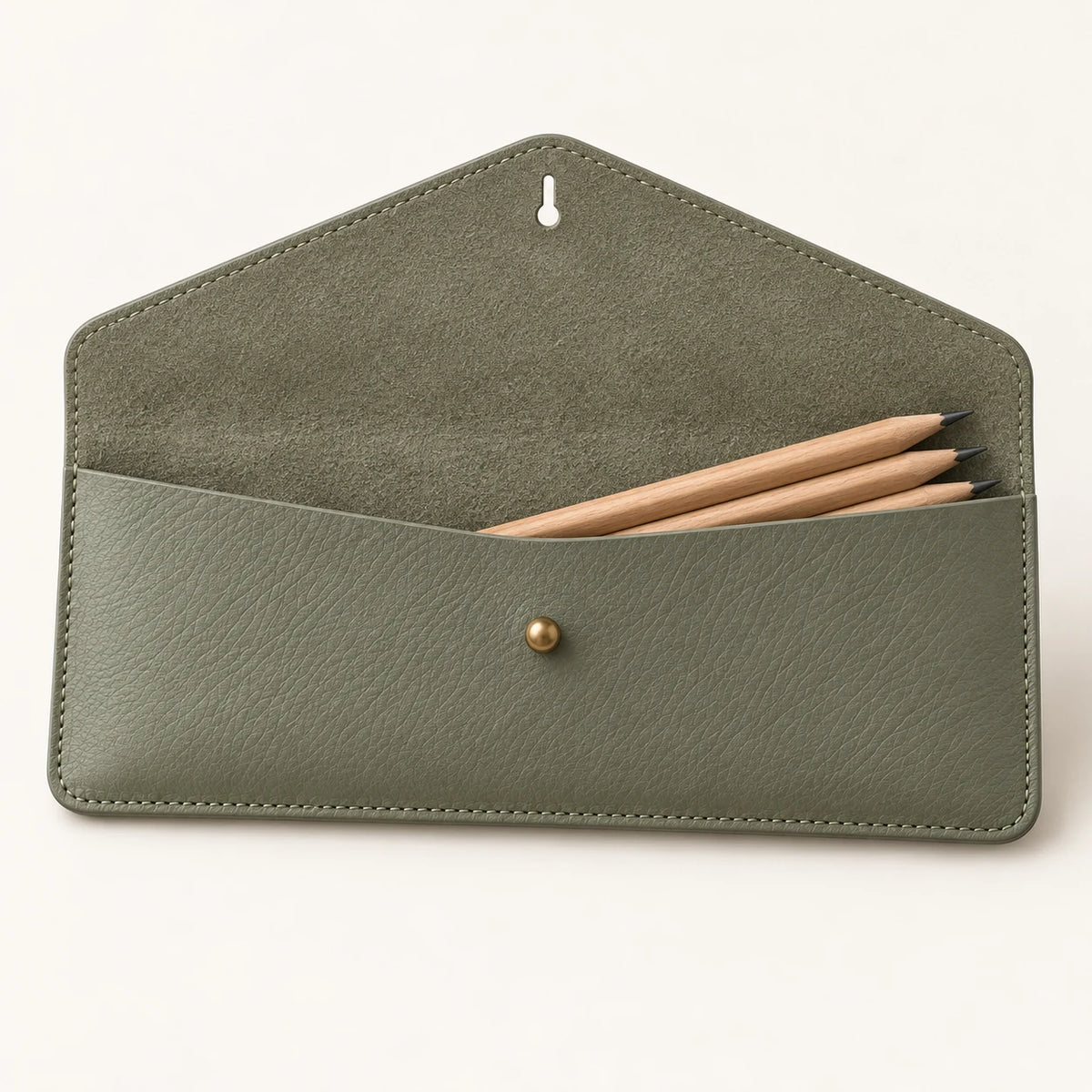 Open envelope flap and single compartment of the sage leather pencil case