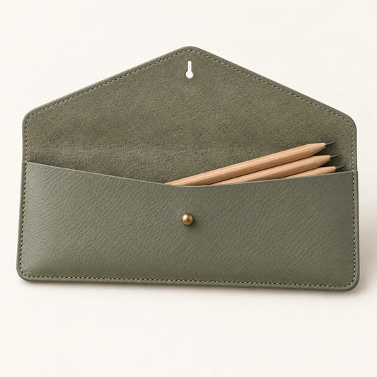Open envelope flap and single compartment of the sage leather pencil case