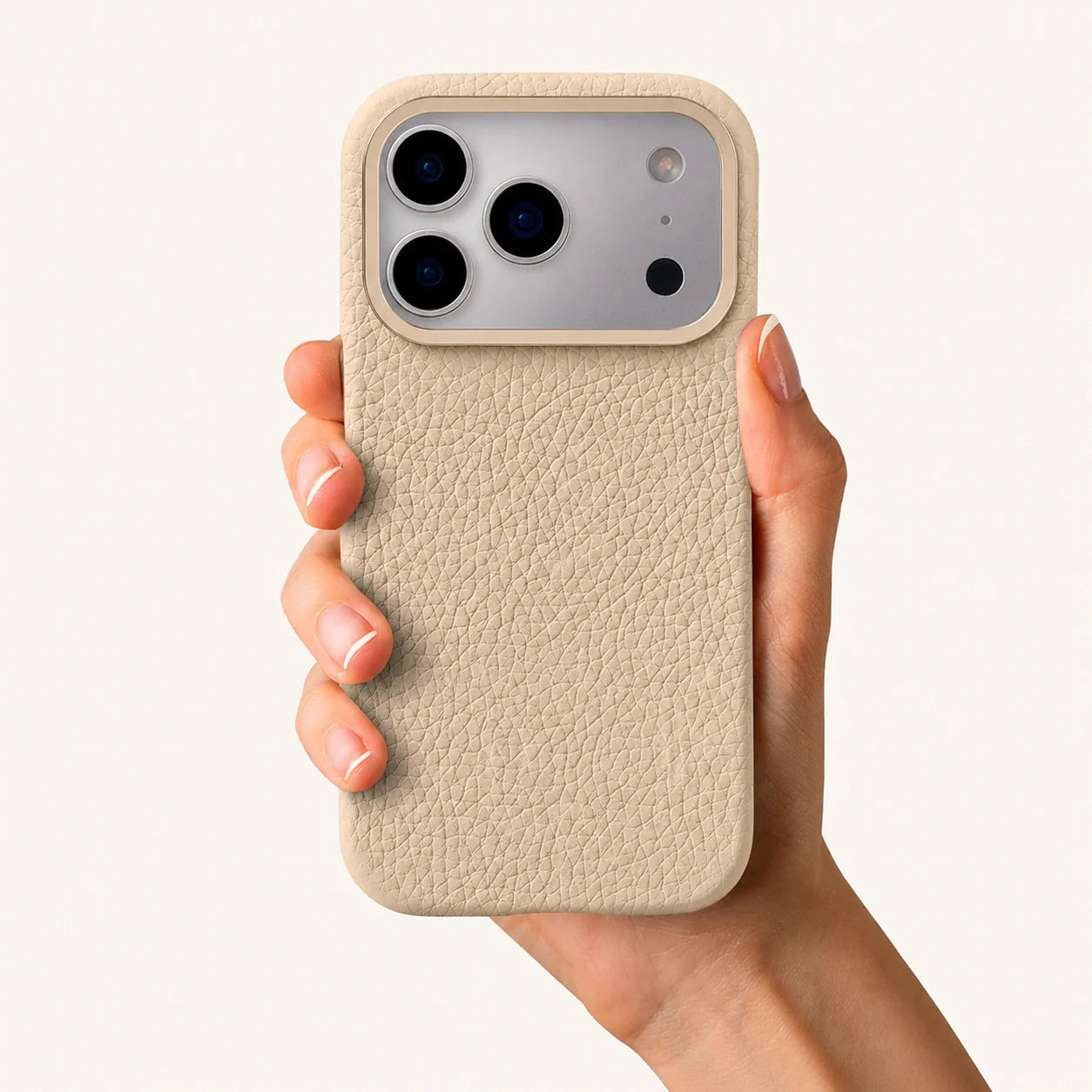 Beige top-grain leather iPhone 17 Pro case in-hand view