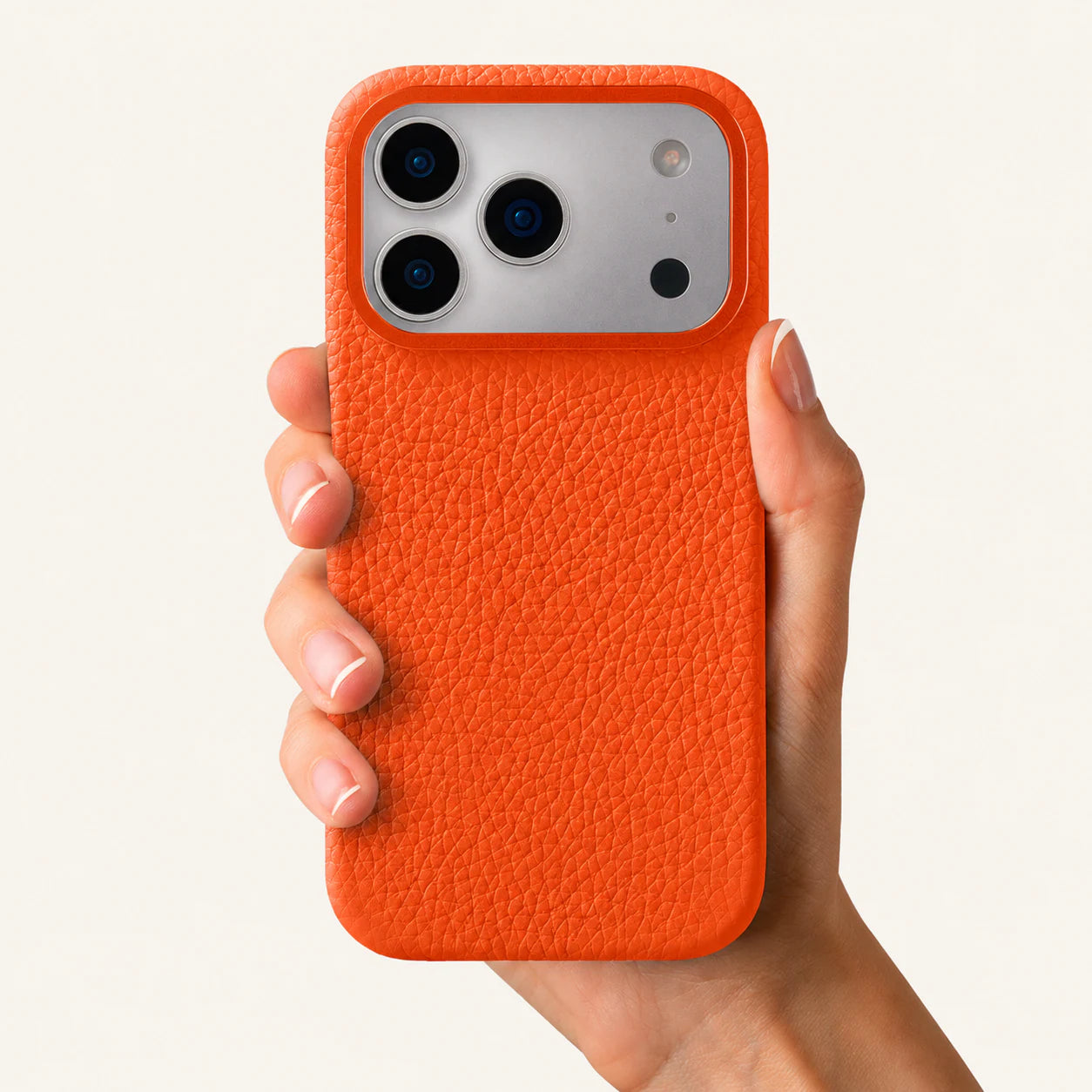 Orange top-grain leather iPhone 17 Pro Max case in-hand view