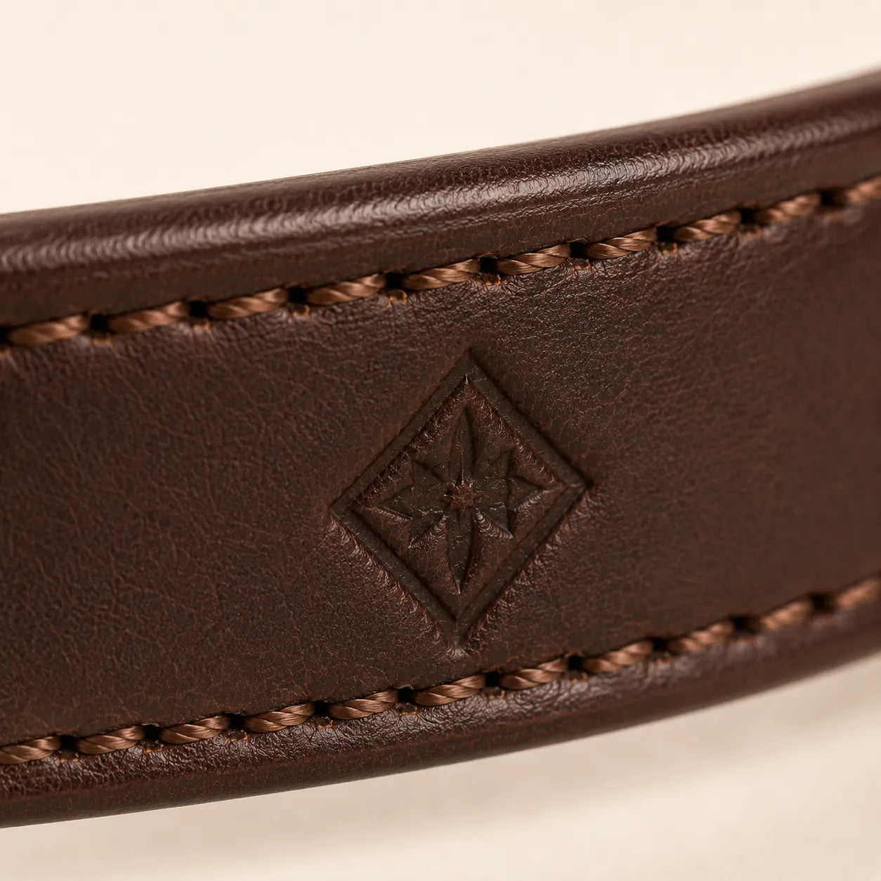 Close-up of blind debossed logo area on leather dog collar