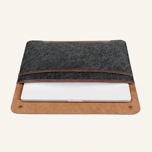 Gray felt and brown leather laptop sleeve open with a laptop inside