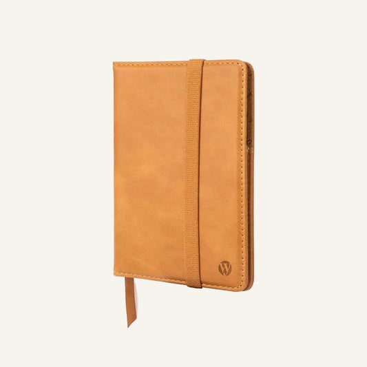 Tan leather passport cover with elastic band, closed front view