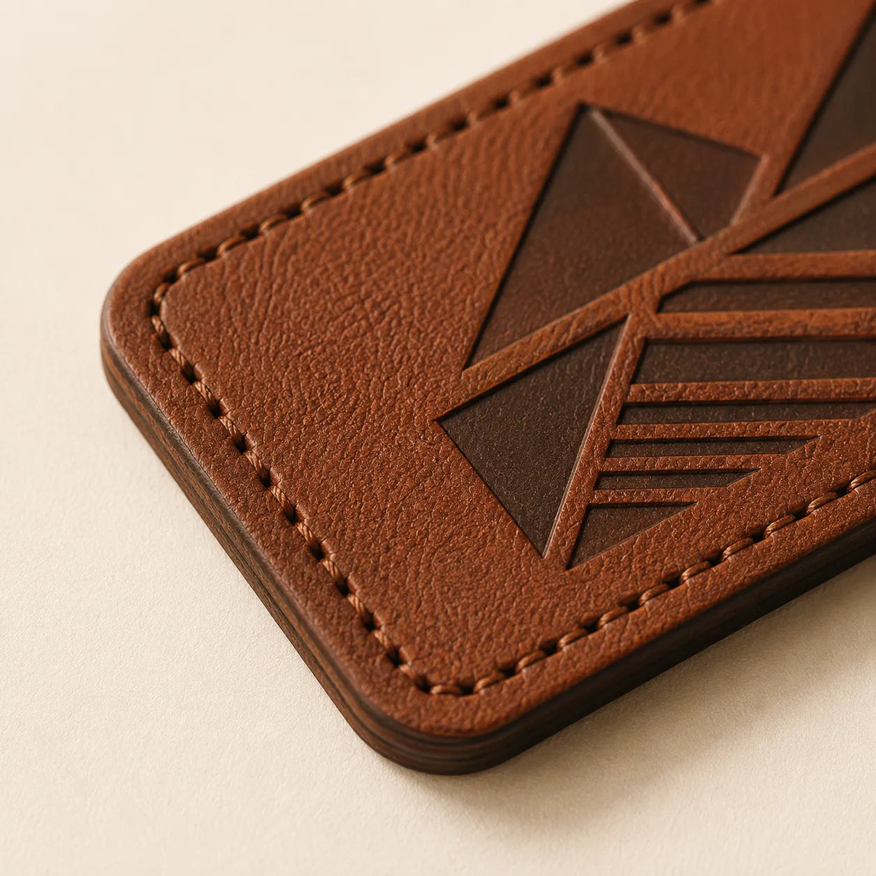 Laser-cut edge stitching holes and leather thickness detail on patch