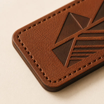 Laser-cut edge stitching holes and leather thickness detail on patch