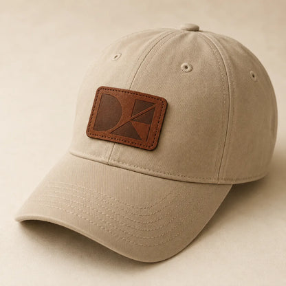 Laser engraved leather patch sewn onto plain neutral baseball cap