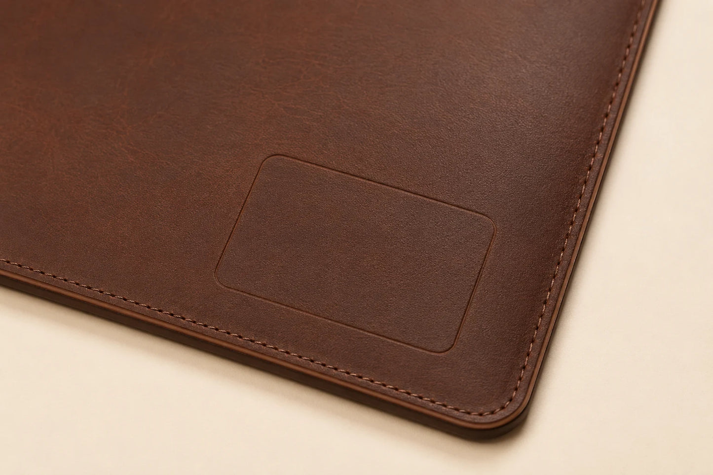 Blank logo customization area on leather desk mat with cable slot