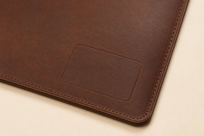 Blank logo customization area on leather desk mat with cable slot