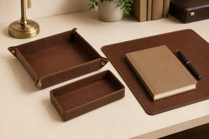 Leather desk organizer tray set arranged with notebook and pen on executive desk