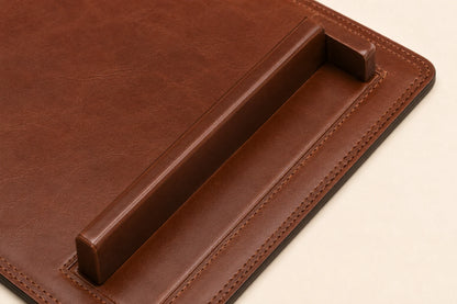 Close-up of raised paper rail stitching and leather grain on desk pad
