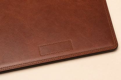 Blank logo debossing area on leather desk pad with stitched border